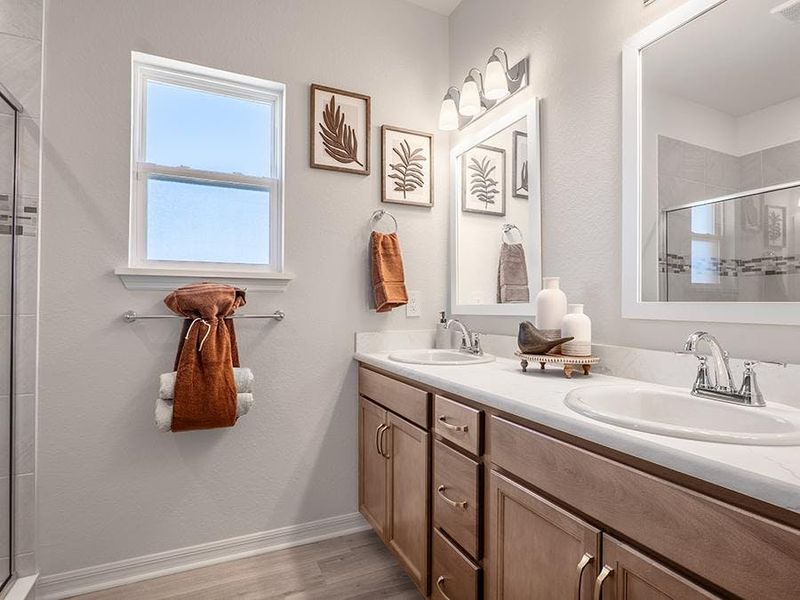 Your suite is complete with a private en-suite bath with a tiled shower, linen closet, and a closeted toilet - Monroe by Highland Homes