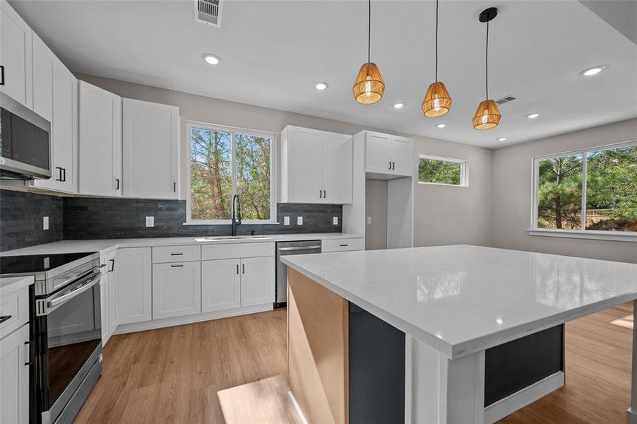 Nice open space with pendulum lights and lots of natural light.