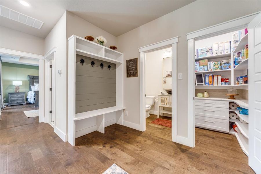 Mudroom with light wood-type flooring and baseboards