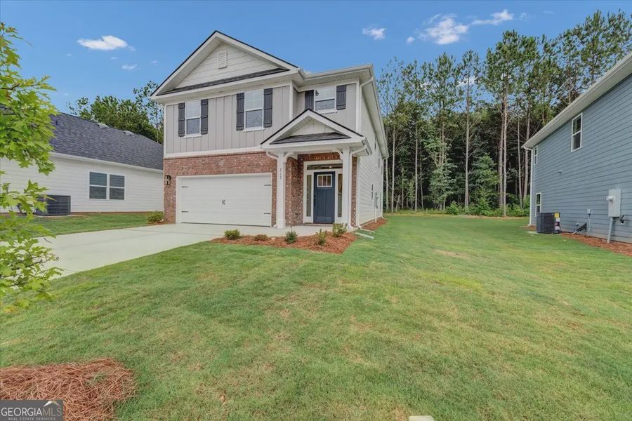 Front exterior of a new home in Canterbury Villas, Carrollton, GA, highlighting curb appeal (Image 20). Front exterior of a new home in Canterbury Villas, Carrollton, GA, highlighting curb appeal (Image 20).