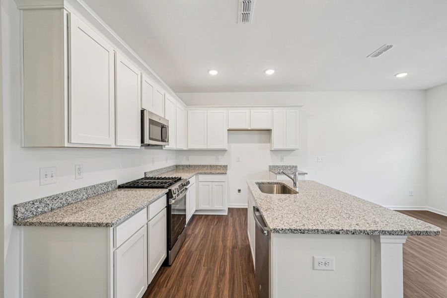 Kitchen - Chic white finishes and smooth surfaces shine.