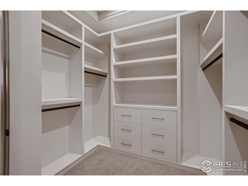 Built in closet shelves and drawers in Master closet connected to laundry room