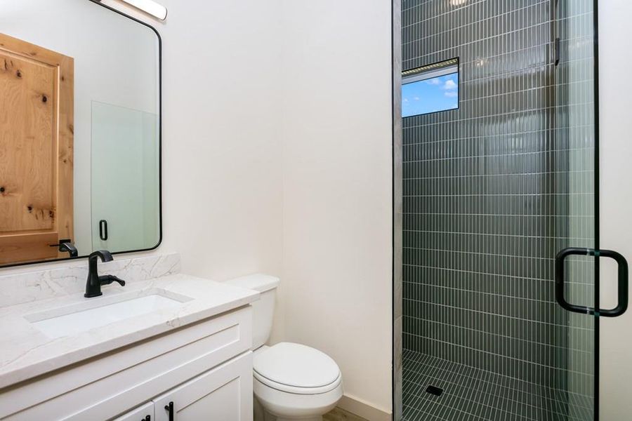 Bathroom featuring vanity and a stall shower Bathroom featuring vanity and a stall shower