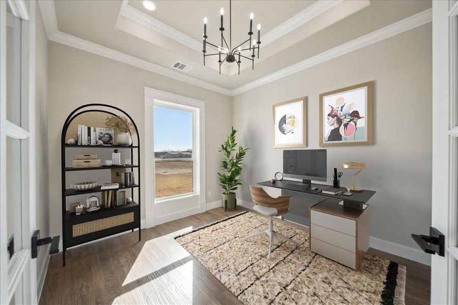 Office space featuring dark hardwood / wood-style floors, ornamental molding, a tray ceiling, and an inviting chandelier