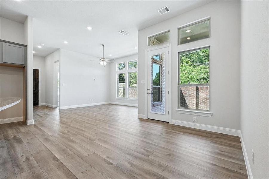 Unfurnished living room featuring a ceiling fan, light wood-style floors, and recessed lighting Unfurnished living room featuring a ceiling fan, light wood-style floors, and recessed lighting