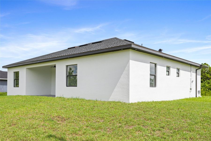 Front exterior of a new home in , Lehigh Acres, FL, highlighting curb appeal (Image 25).