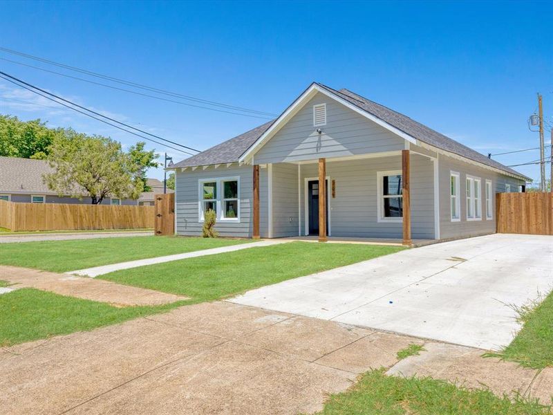 View of front of house with roof with shingles and covered porch
