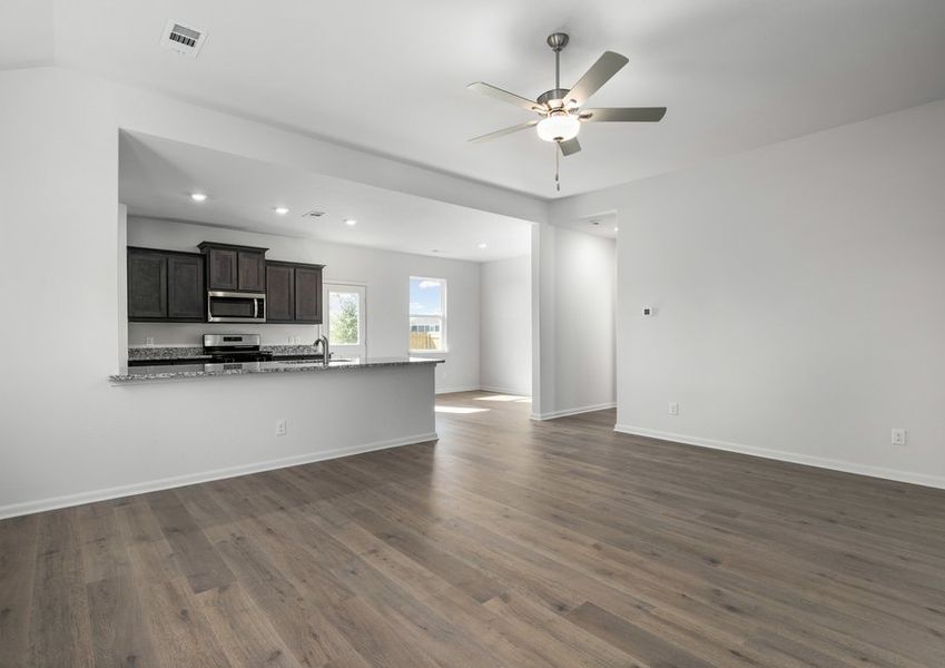 The kitchen, dining room and living room sit adjacent to one another.
