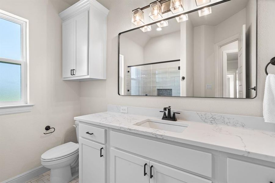 Guest Bathroom with Walk-In Shower, Storage Cabinetry & Decorative Hardware and Tile.