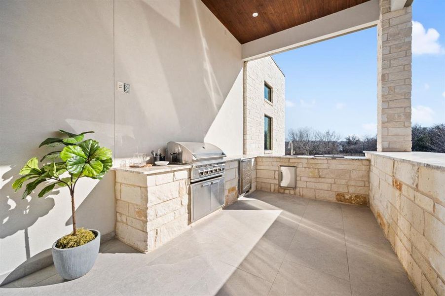 View of patio featuring area for grilling and outdoor kitchen