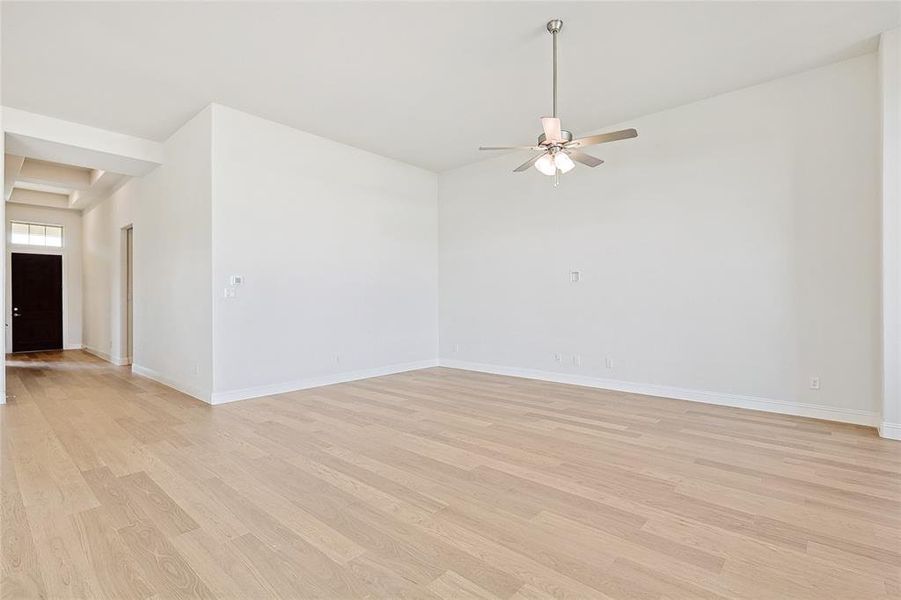 Spare room with ceiling fan and light hardwood / wood-style floors