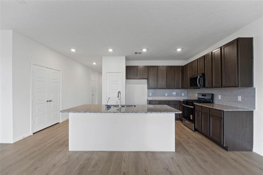 This spacious kitchen has it all—ample storage, generous counter space, and a layout that truly makes it the heart of the home.