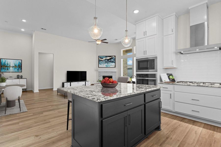 Gourmet kitchen featuring beautiful granite countertops, custom accent center island with contrasting cabinetry, pendant lighting, and stainless-steel appliances.  What a home, it's a CastleRock Community Home that's why! Just around the corner is a private Home Office for those that get to work from home off and on! *Virtually Staged*