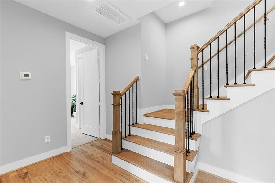 A traditional wood staircase with intricate carvings and a sweeping handrail, exuding timeless elegance and craftsmanship.