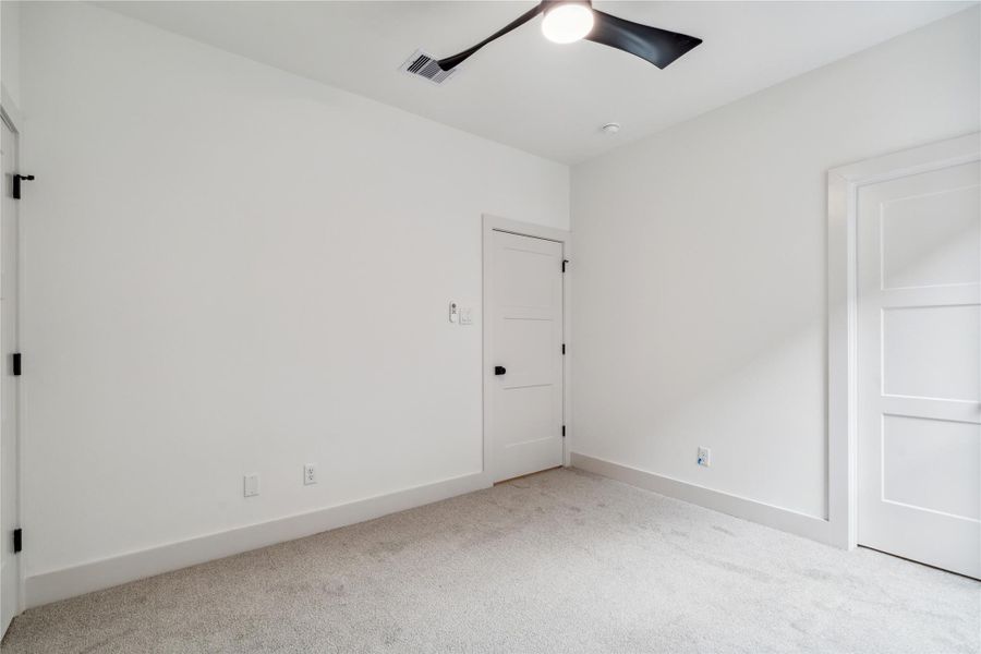 Tucked away with easy access to the hallway bath, this third bedroom offers peaceful comfort for guests, kids, or work-from-home needs.