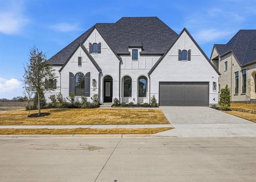 Front exterior of a new home in Mustang Lakes, Celina, TX, highlighting curb appeal (Image 1). Front exterior of a new home in Mustang Lakes, Celina, TX, highlighting curb appeal (Image 1).