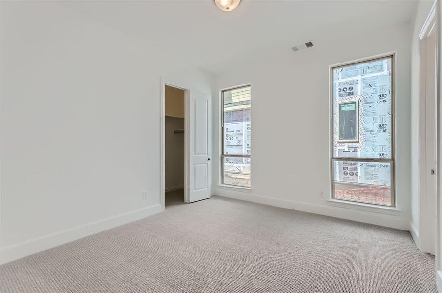 Unfurnished room with light colored carpet