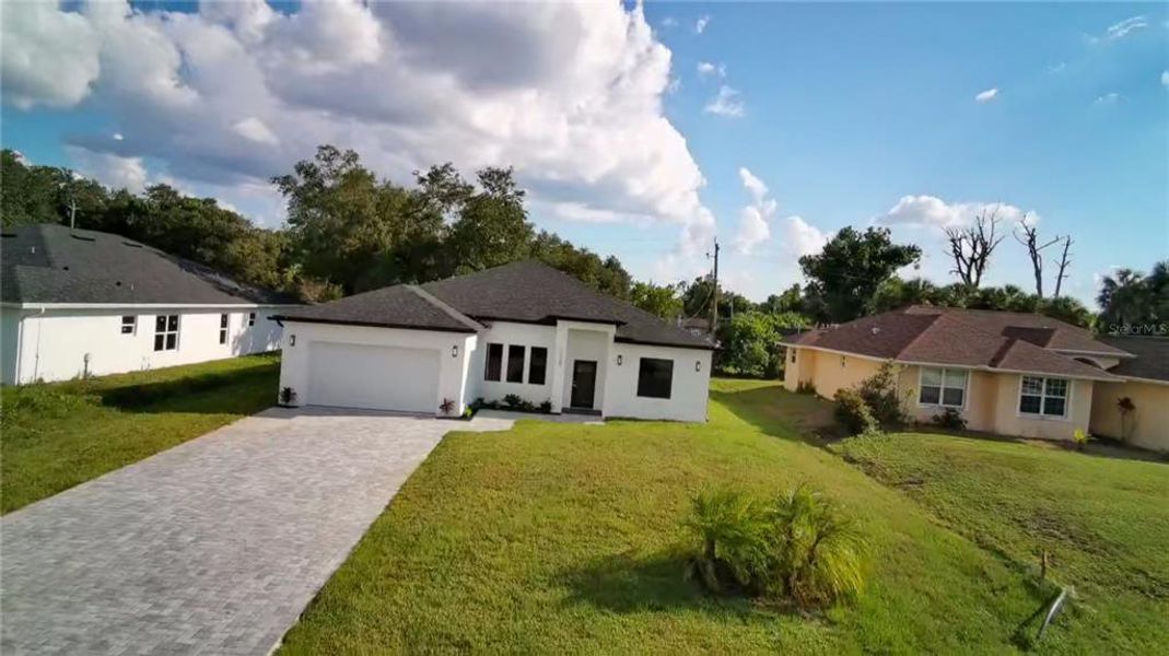 Front exterior of a new home in , Port Charlotte, FL, highlighting curb appeal (Image 2).