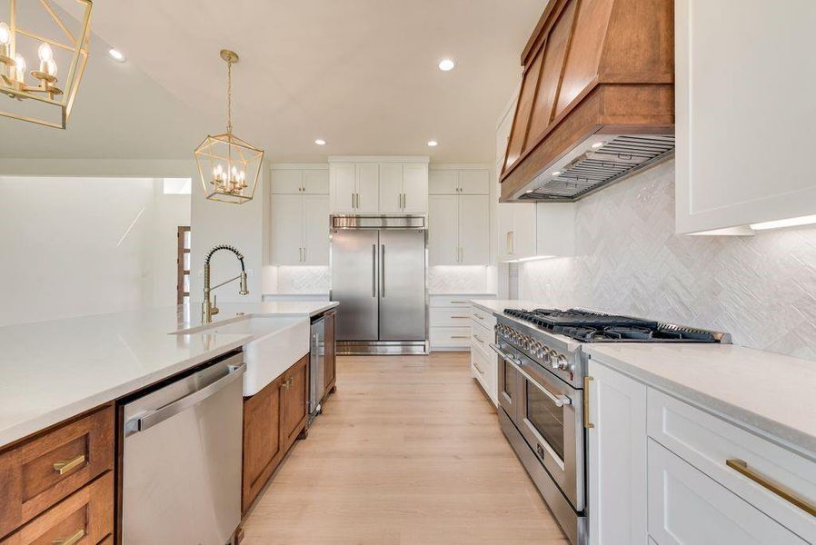 60 inch built in subzero style fridge, gas range w 6 burners, 2 oven doors and grilddle