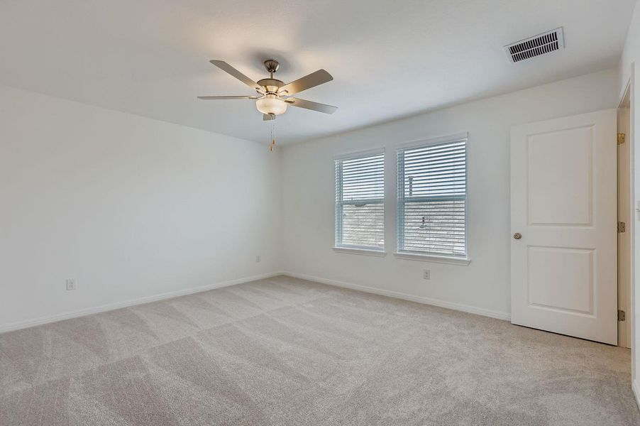 Unfurnished room with light carpet and ceiling fan Unfurnished room with light carpet and ceiling fan