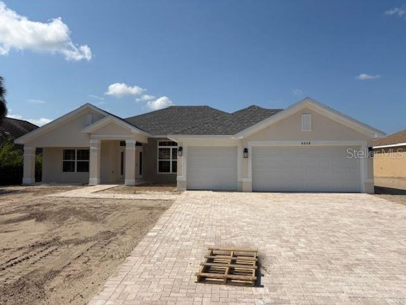 Front exterior of a new home in Juliette Falls, Dunnellon, FL, highlighting curb appeal (Image 9).
