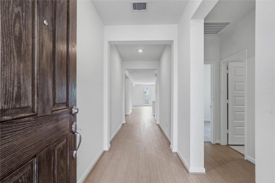 Step into a bright and welcoming foyer that sets a sophisticated tone for the rest of the home. This inviting entrance features Bandera Toasted Sienna Vinyl Plank flooring that seamlessly guides you into the main living areas.
