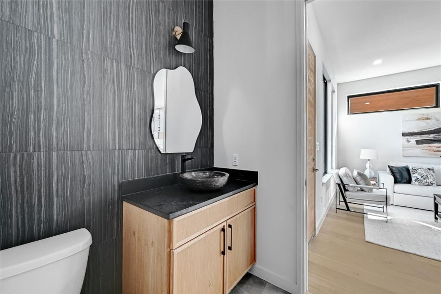 Bathroom featuring hardwood / wood-style floors, toilet, and vanity