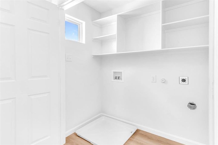 Laundry area featuring electric dryer hookup, hookup for a gas dryer, wood-type flooring, and hookup for a washing machine