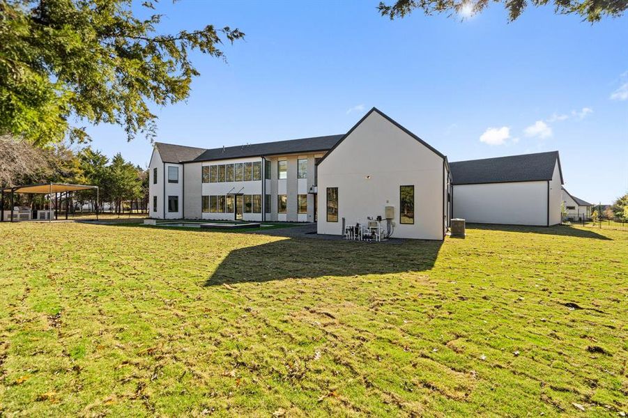 Rear view of house with a yard and cooling unit