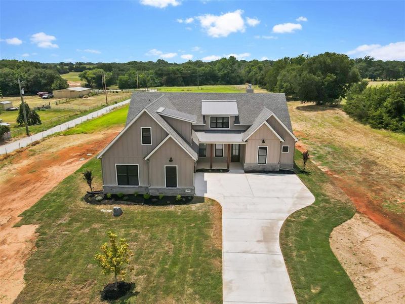 Modern farmhouse style home featuring a front yard