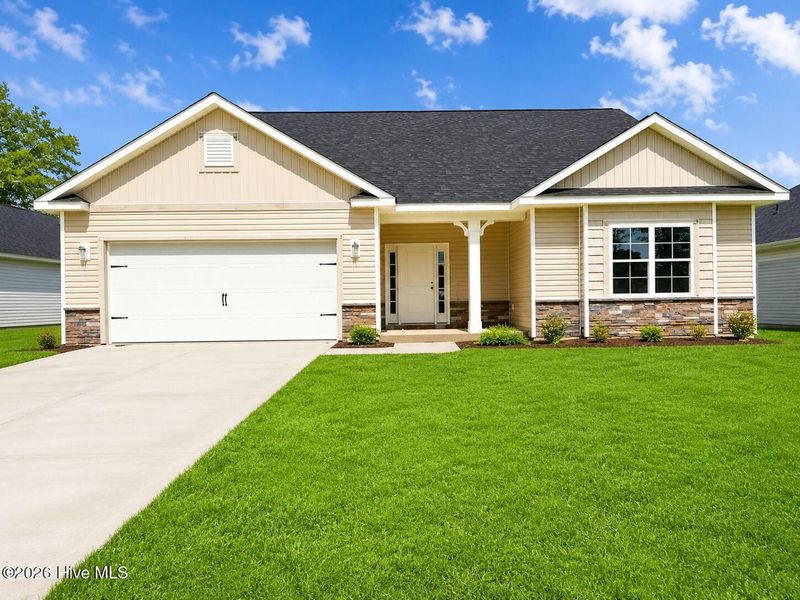 Front exterior of a new home in Wood Creek Landing, Leland, NC, highlighting curb appeal (Image 1). Front exterior of a new home in Wood Creek Landing, Leland, NC, highlighting curb appeal (Image 1).