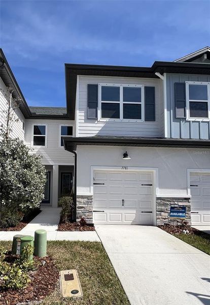 Front exterior of a new home in The Towns At Long Bayou, Seminole, FL, highlighting curb appeal (Image 17).