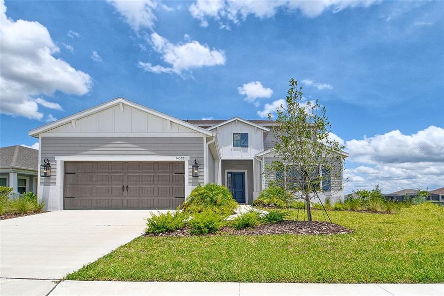 Front exterior of a new home in Canoe Creek, Parrish, FL, highlighting curb appeal (Image 24).