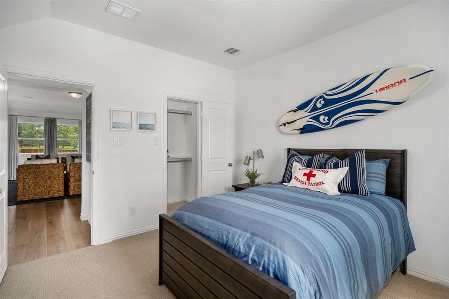 Bedroom featuring hardwood / wood-style flooring and vaulted ceiling