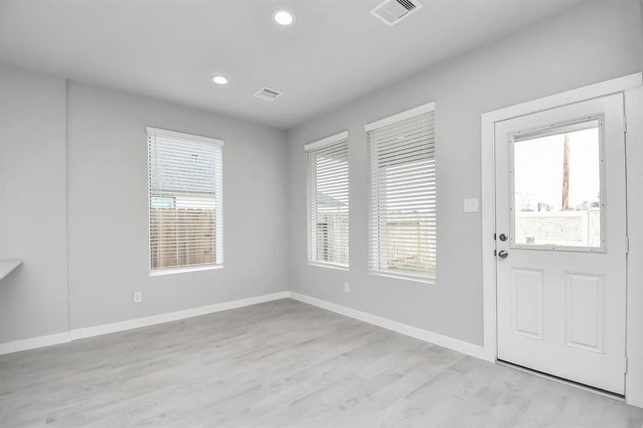 Create lasting memories with your family and friends at the dining table! This expansive dining room showcases sophisticated flooring, custom paint, and seamlessly connects to the family room and kitchen, providing an open and inviting atmosphere!