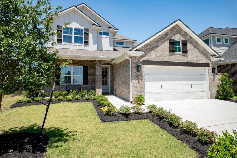 Front exterior of a new home in Greens Prairie Reserve, College Station, TX, highlighting curb appeal (Image 21).