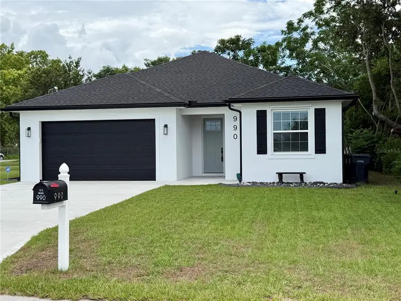 Front exterior of a new home in , Eagle Lake, FL, highlighting curb appeal (Image 2). Front exterior of a new home in , Eagle Lake, FL, highlighting curb appeal (Image 2).