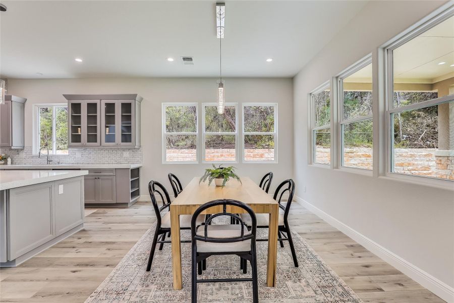 Dining room featuring light wood-type flooring, plenty of natural light, and sink