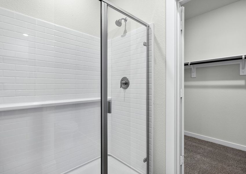 The master bathroom has a glass, walk-in shower.