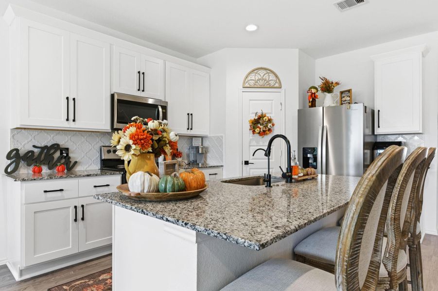 Gourmet kitchen featuring granite countertops, stainless steel appliances, and a large eat-in island. Gourmet kitchen featuring granite countertops, stainless steel appliances, and a large eat-in island.