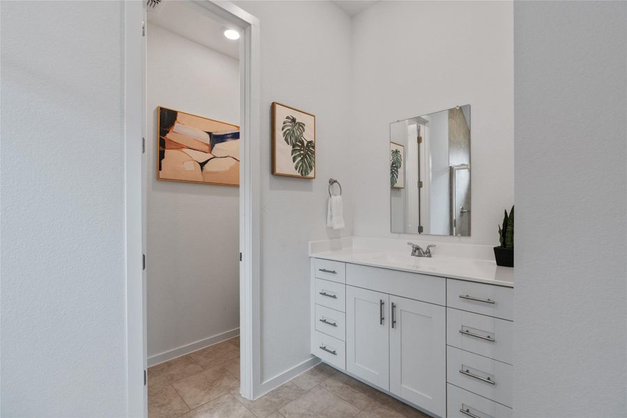 A pristine vanity with dual sinks, sleek cabinetry, and a well-lit space perfect for daily routines.