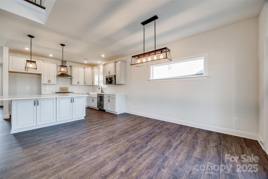 View of dining area into kitchen--note cabinets on all sides of the island!