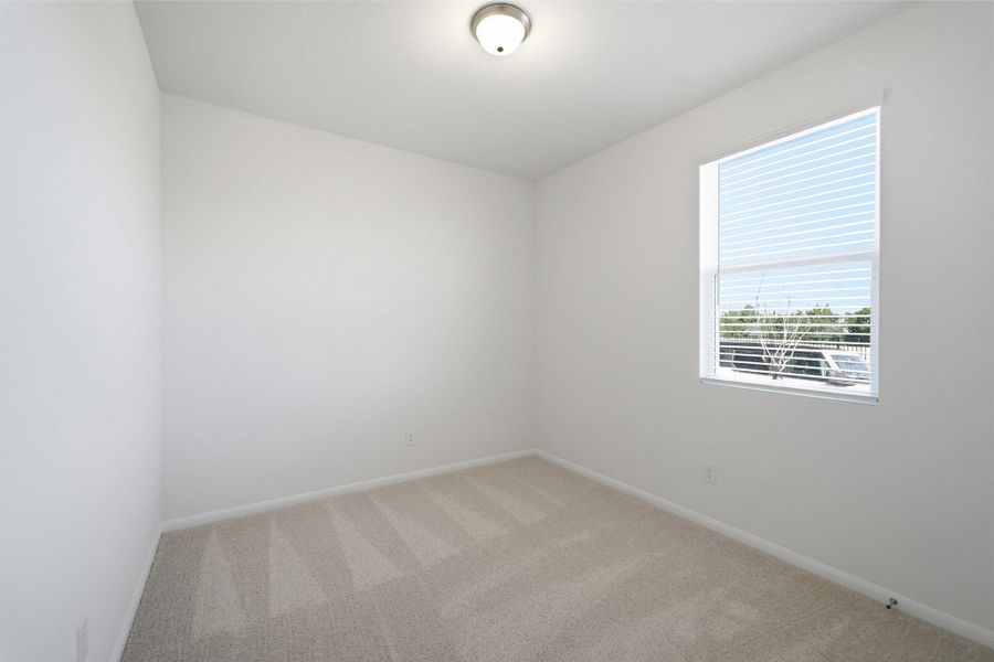 Empty room with light carpet and baseboards Empty room with light carpet and baseboards