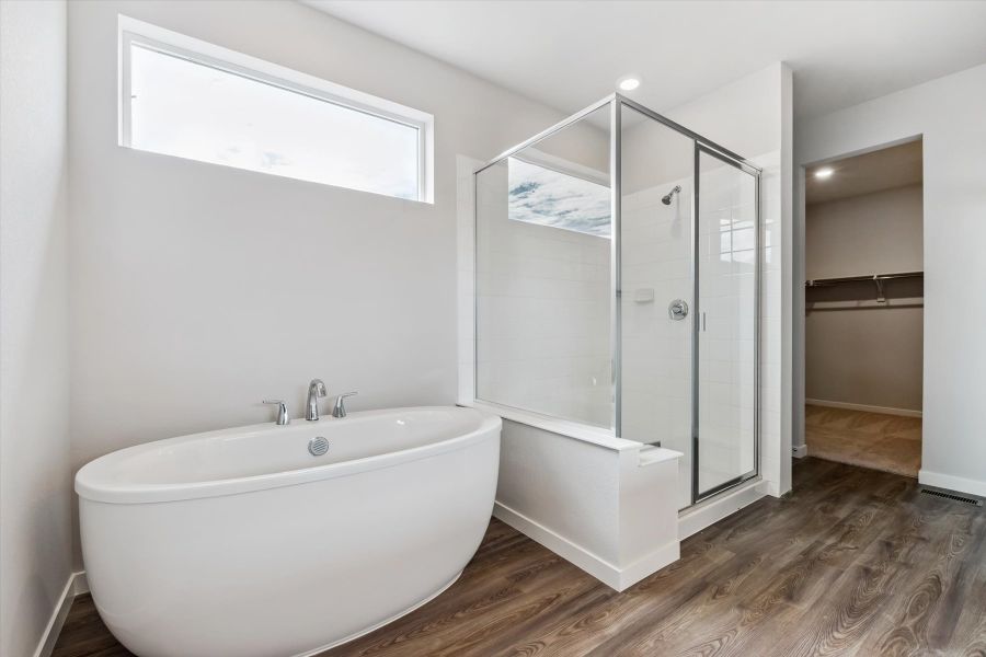 A bathroom with a tub and shower.
