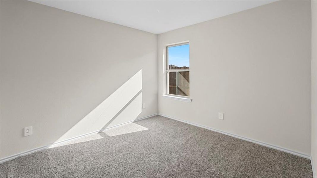 Empty room with carpet flooring and baseboards