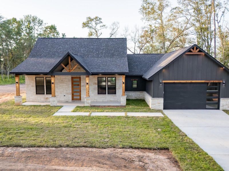 The covered front porch is perfect for relaxing with a cup of coffee, finished with recessed lighting and sleek black sconce fixtures for day-to-night curb appeal. The covered front porch is perfect for relaxing with a cup of coffee, finished with recessed lighting and sleek black sconce fixtures for day-to-night curb appeal.