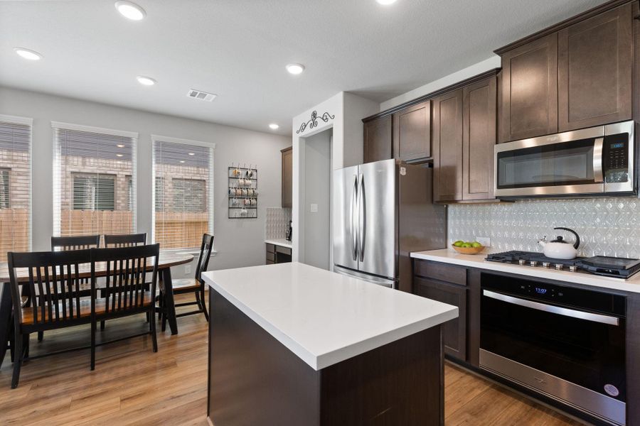 Kitchen comes complete with stainless appliance, 5 burner gas cooktop and a walk in pantry with custom shelving.