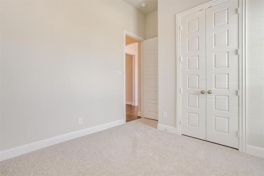 Unfurnished bedroom featuring a closet and carpet flooring