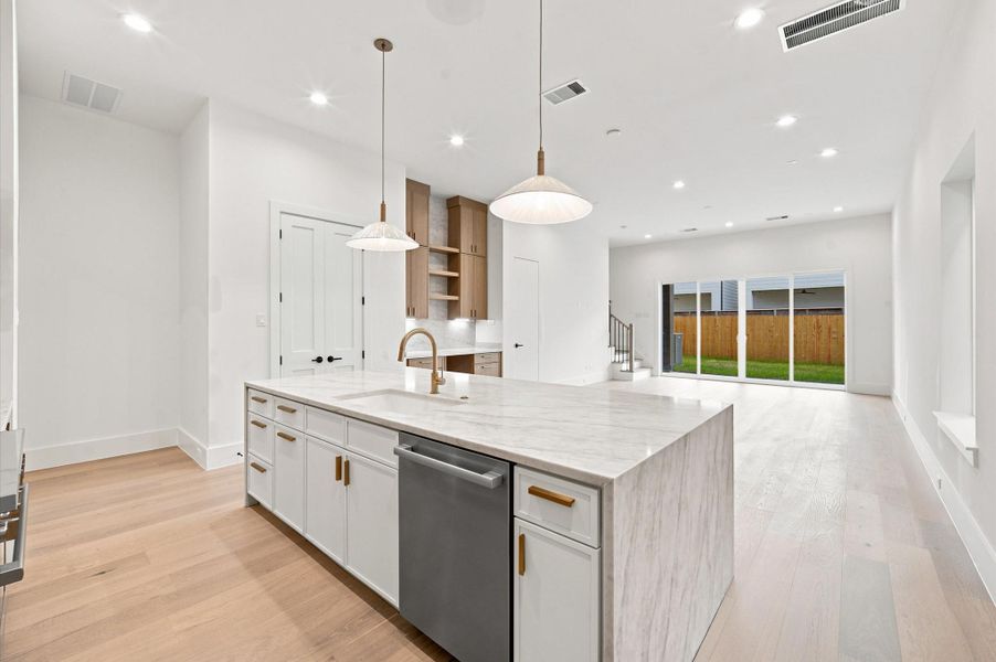 Open-concept layout connecting the kitchen, dining and living areas.