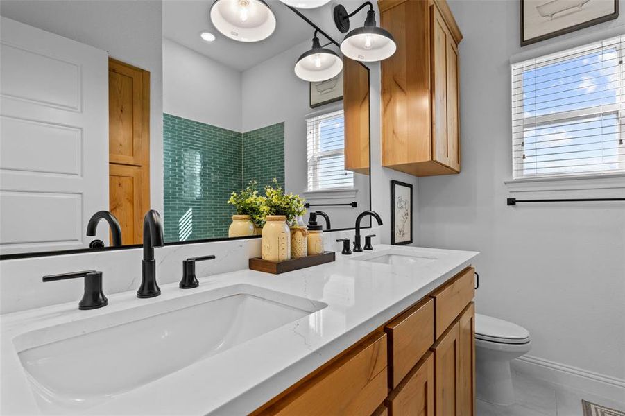 Bathroom featuring tile patterned flooring, vanity, and toilet